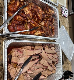 Catering pans of BBQ chicken and smoked brisket fresh off the pit