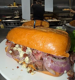 Steak sandwich with blue cheese and red onion