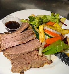 Sliced brisket plate with roasted vegetables