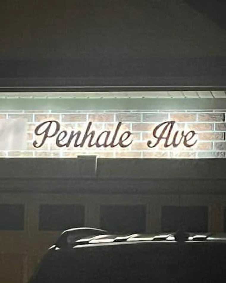 Backlit illuminated address sign glowing at night