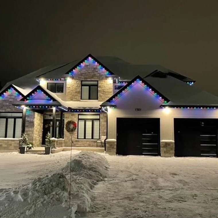 Permanent LED roofline lighting on a snowy Ontario home