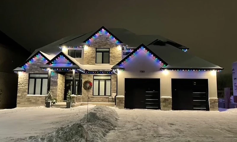 Permanent roofline lighting installation on a custom home in Ontario