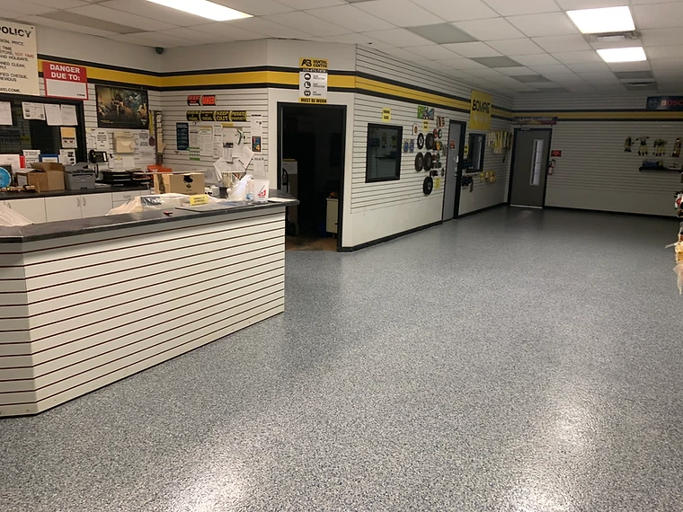 High-gloss epoxy flake floor in a commercial showroom