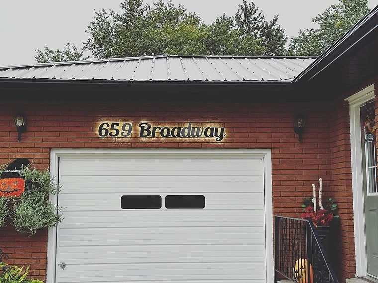 Non-illuminated custom address sign mounted on a home