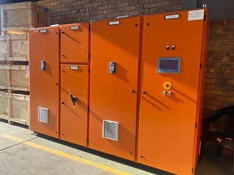 Orange MCC exterior — HMI, e-stop, indicator stack