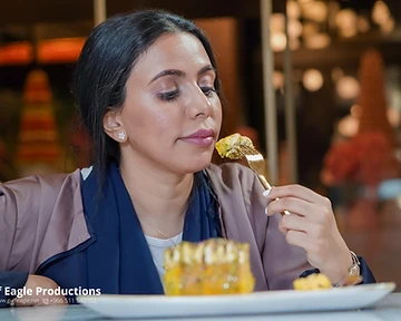 Diner tasting a dessert course at a café brand shoot in Riyadh