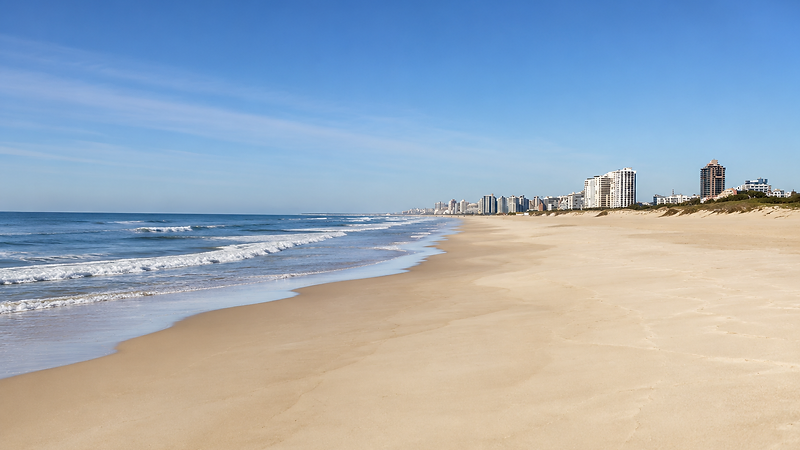 Wooden boardwalk leading toward the Punta del Este beach and ocean