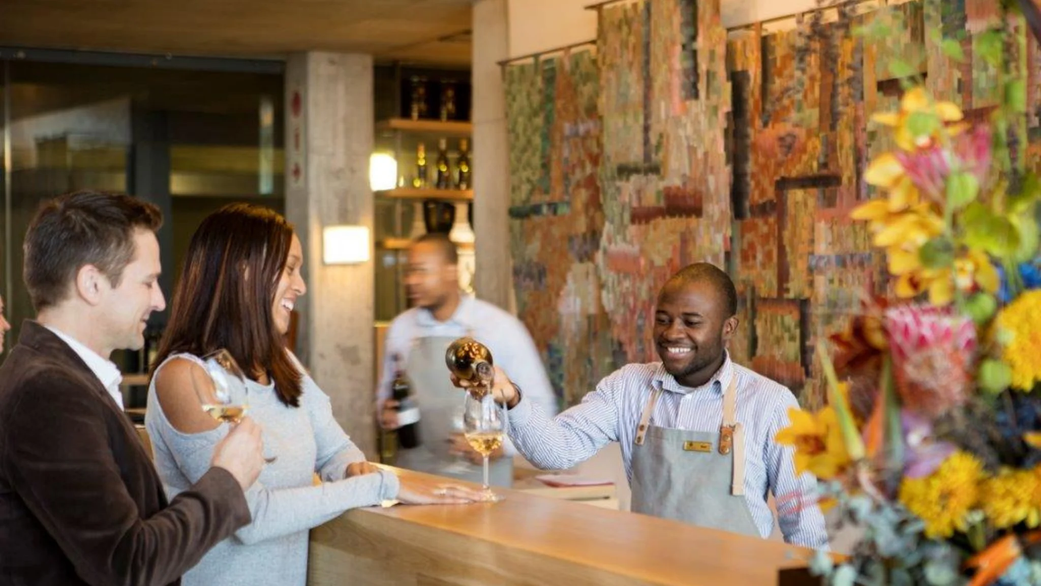People at Tokara Estate laughing and drinking wine