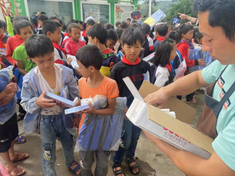 Volunteer distributing supplies to children