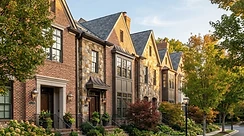 Refined Northern Virginia brick townhomes in early-autumn light.