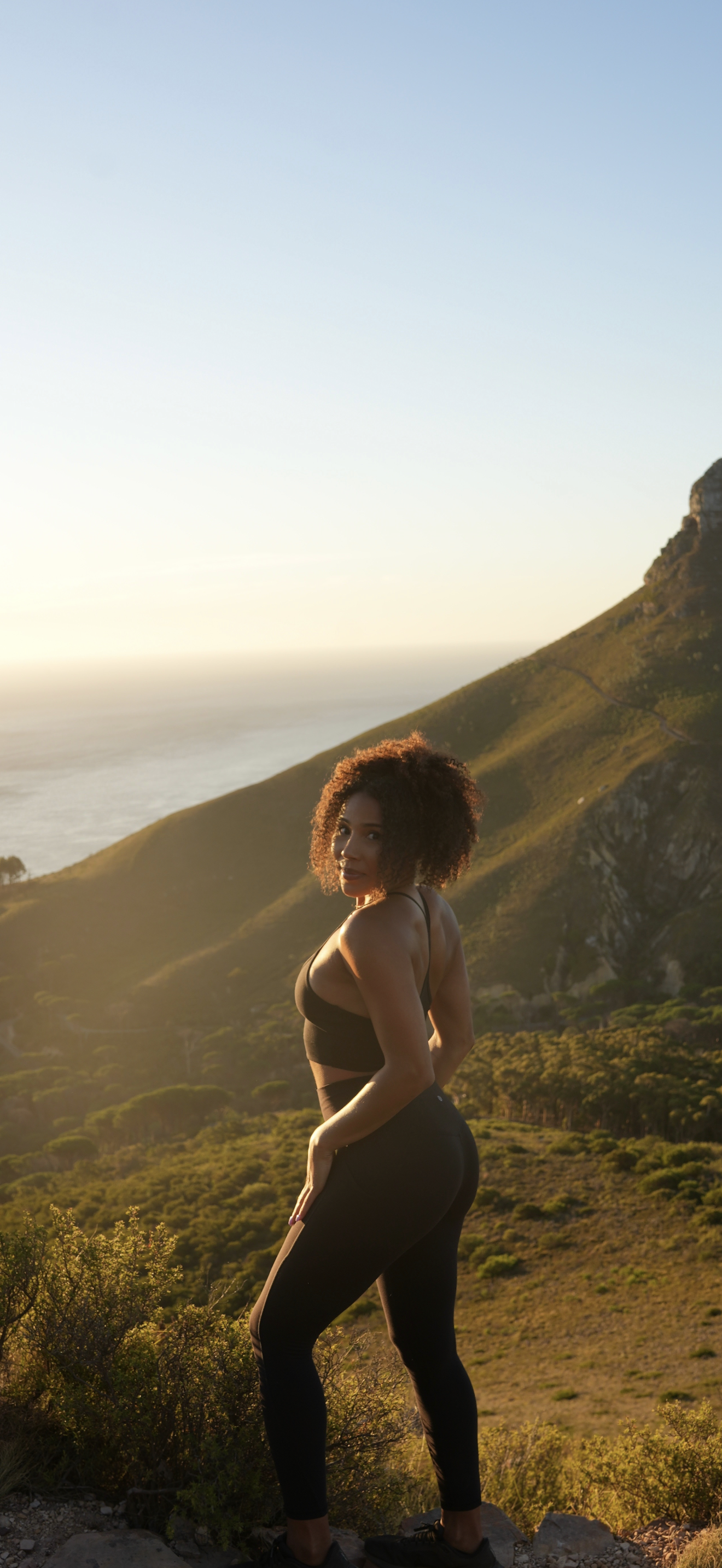 Taliya on a mountain ridge looking back over her shoulder