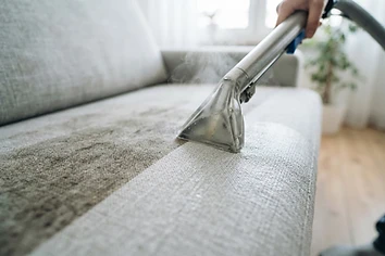 Professional upholstery cleaning of a light grey linen sofa in Calgary