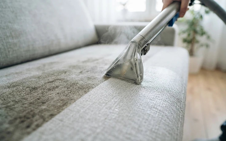 Professional upholstery cleaning of a light grey linen sofa in Calgary