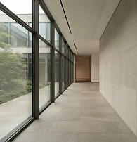 Quiet institutional interior with granite walls, architectural glass and natural light