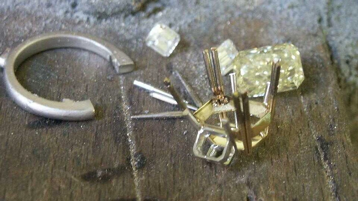 Macro view of a diamond being set into a platinum ring