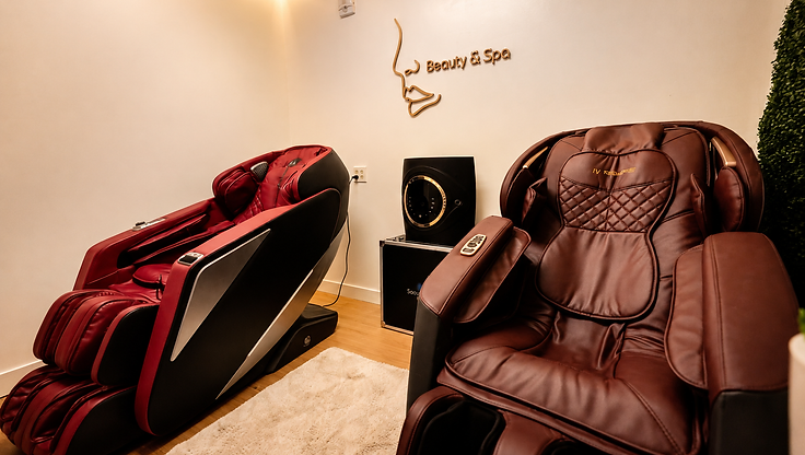 Relaxation room with massage recliners at Pure Luminosity Spa