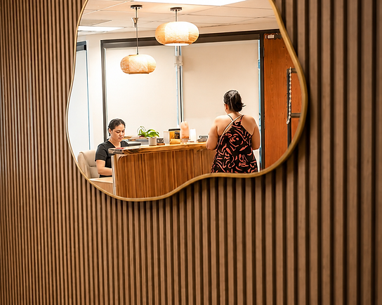 Front desk reflected in a sculptural mirror at Pure Luminosity Spa