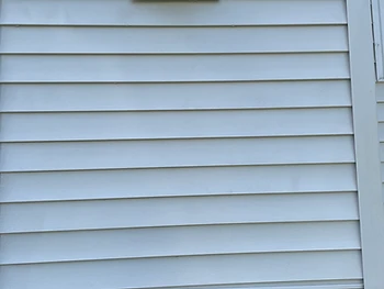 The same vinyl siding after a soft wash, clean and bright