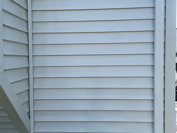 The same siding after a soft wash, clean and uniform