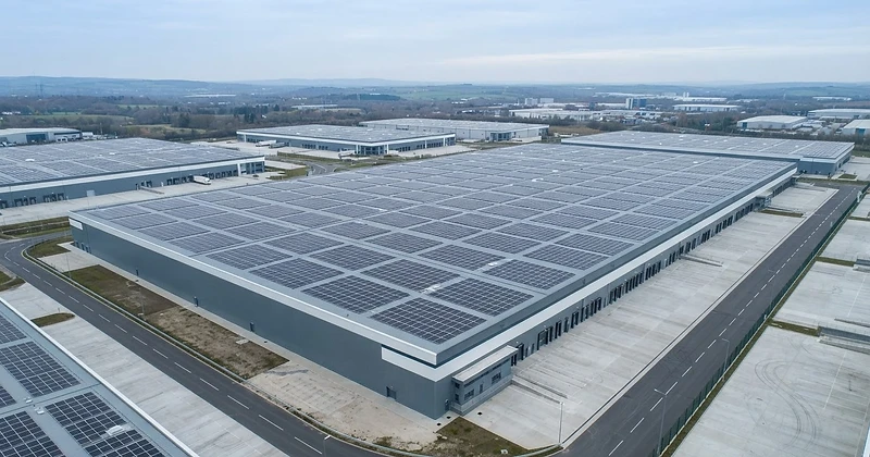 Large warehouse roof covered with rows of solar panels in a Milton Keynes style distribution park