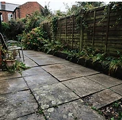 Grey concrete paving slabs after cleaning with the natural surface colour more visible