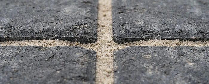 Macro view of clean block paving joints refilled with kiln-dried sand