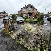 Concrete driveway showing years of traffic dirt, moss and weathering before cleaning