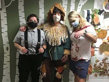 Scarecrow, zombie, and suspender trio