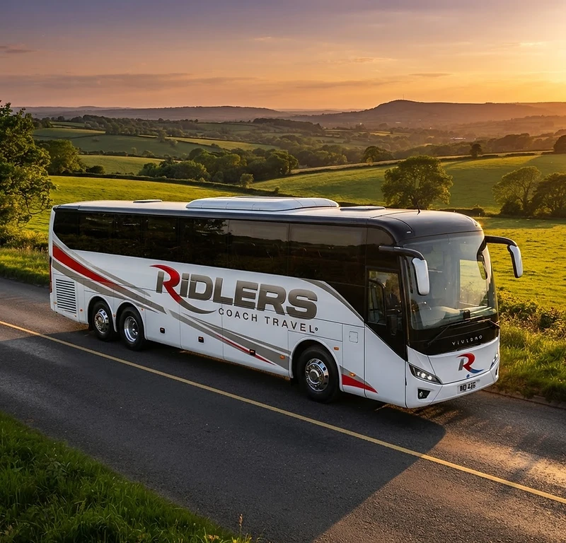 Ridlers luxury coach on a scenic road at sunset