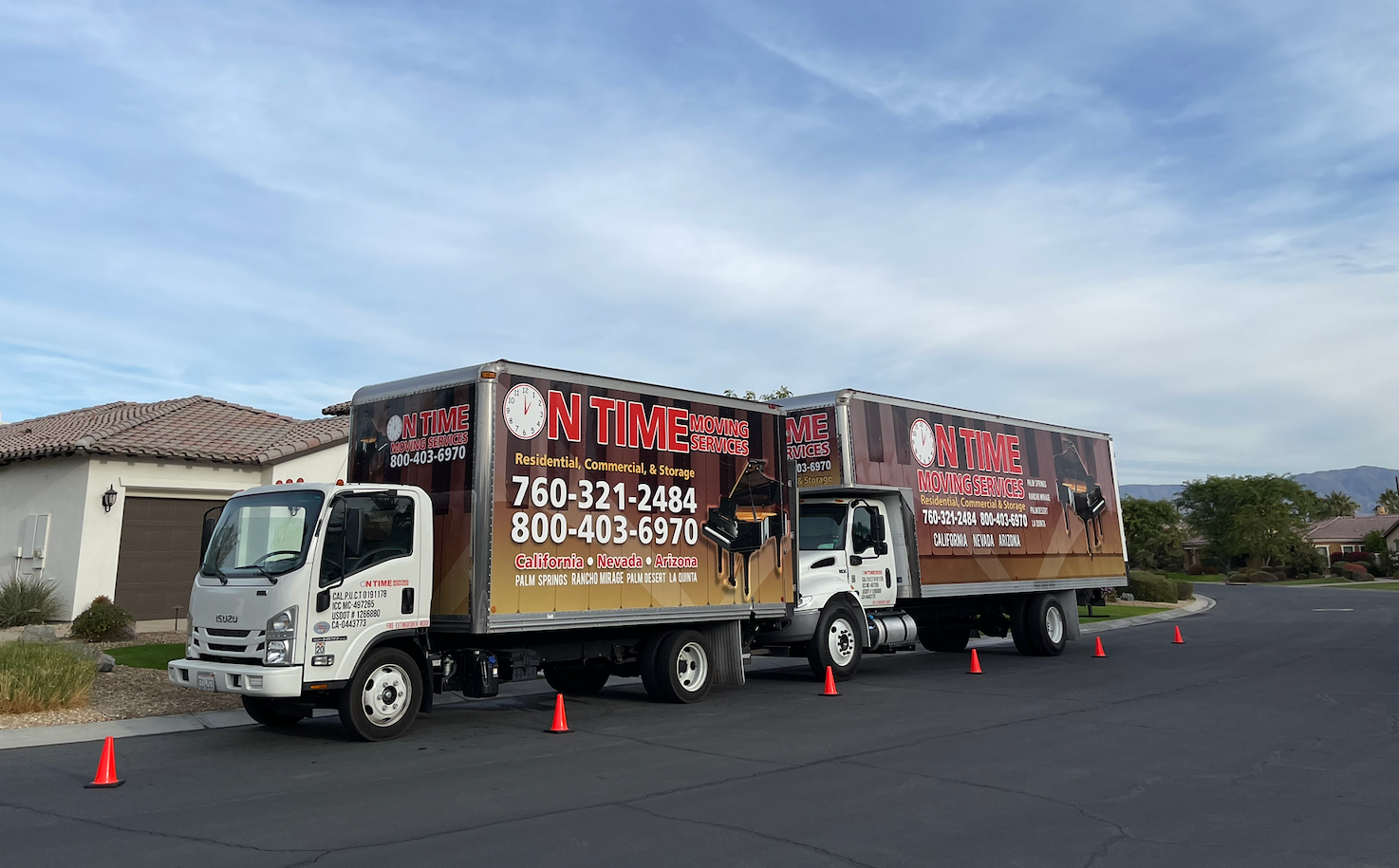 Two moving trucks parked on a residential street