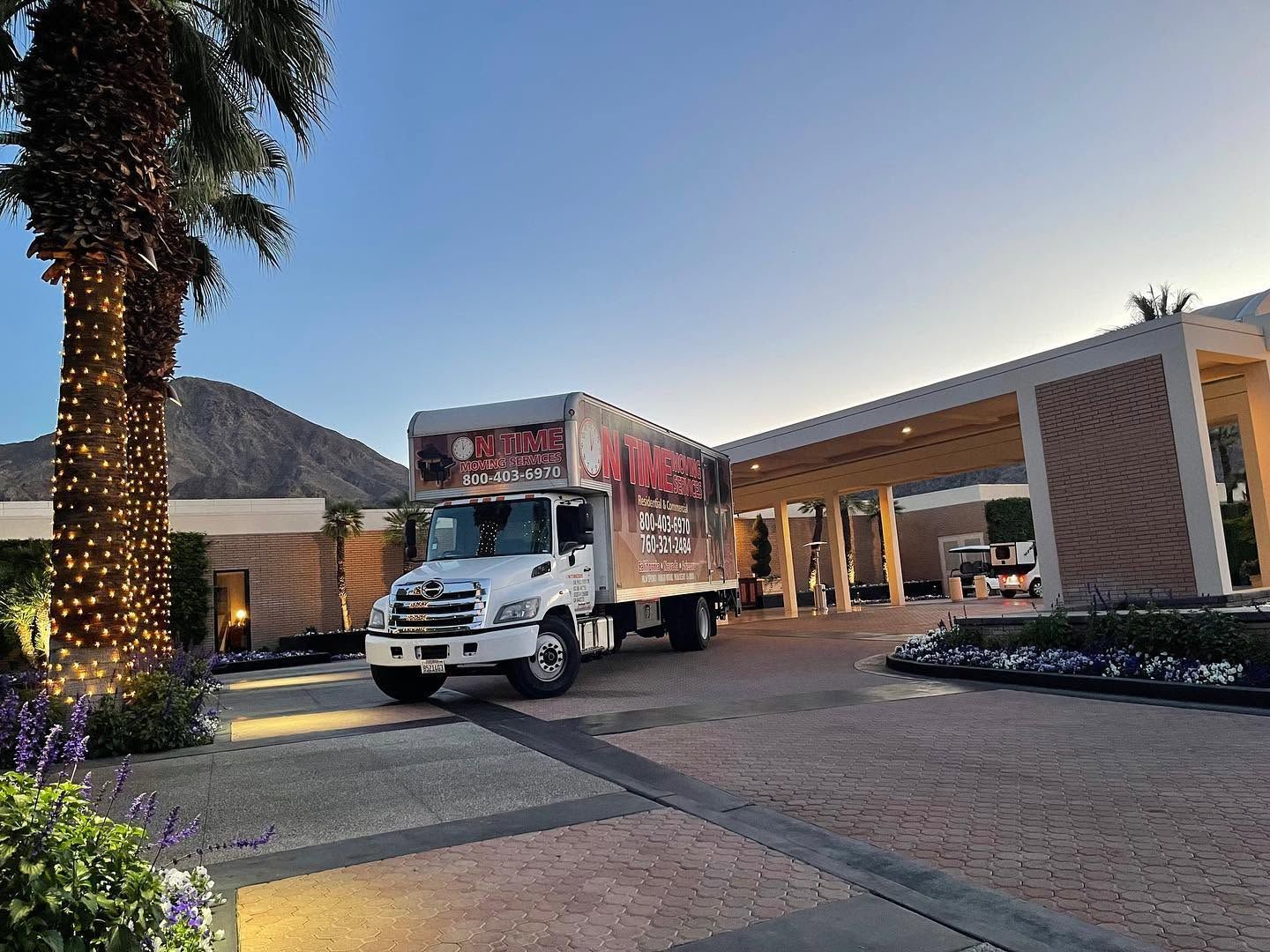 Moving truck parked at a luxury estate at golden hour