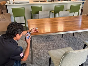 Moving professional documenting furniture condition with a smartphone inventory sticker