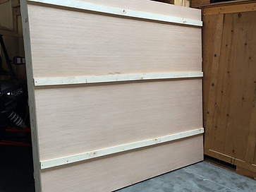Custom-built wooden shipping crate inside a warehouse
