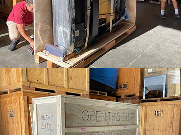 Grand piano being enclosed in a custom wooden crate with a drill