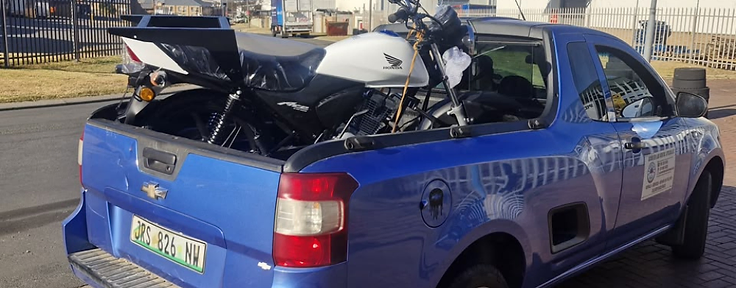 Honda Ace delivery motorcycle loaded onto a bakkie for parts and service in Potchefstroom
