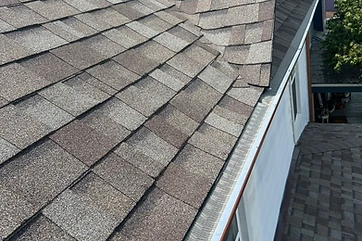 Gutter run along a shingle roof edge during a repair visit