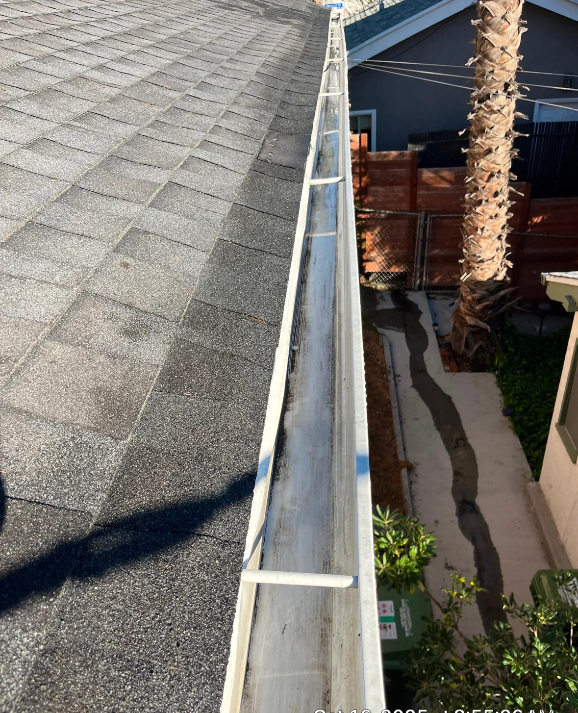 Freshly cleaned gutter run viewed from the roof