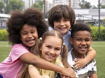 A group of children smiling together, representing the youth Right Step serves