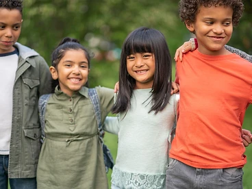 A group of children together outdoors, representing the youth Right Step serves