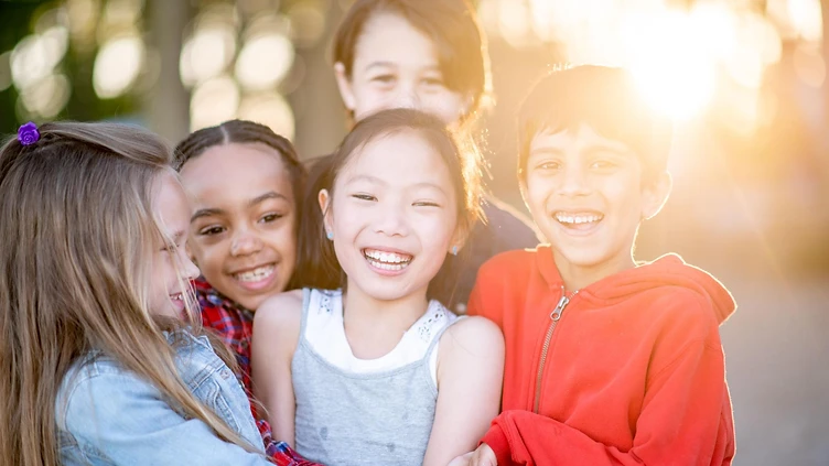 A group of children smiling together, representing the youth Right Step serves