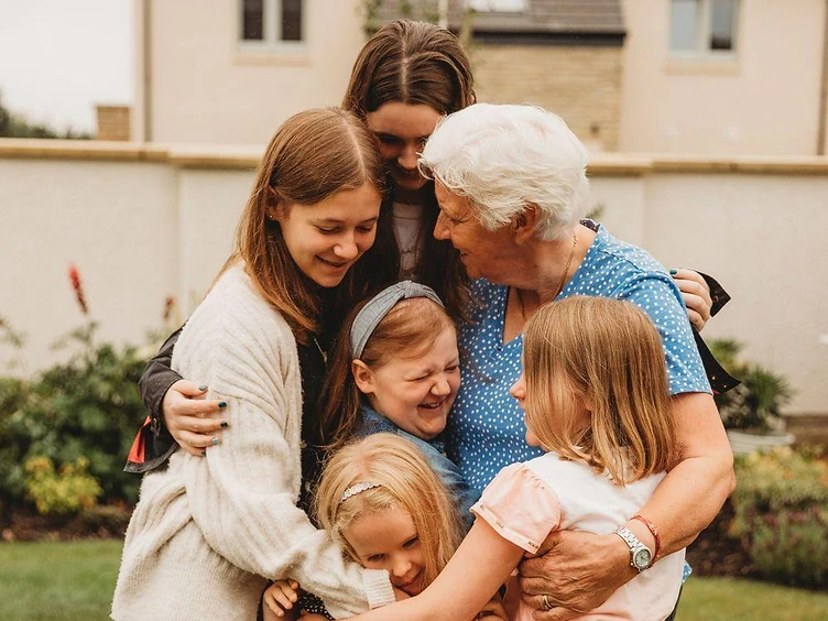 A multi-generational family embracing, representing the families Right Step serves