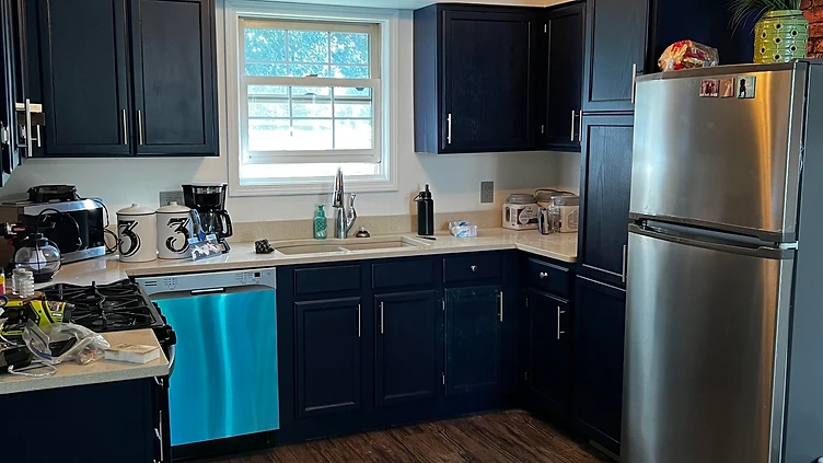Kitchen cabinets repainted dark navy with new hardware Indiana