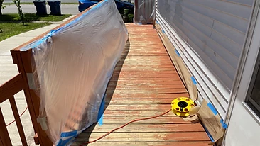 Deck railing and siding protected with masking paper and tape Indiana