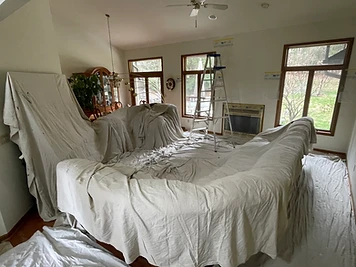 Sectional sofa covered with canvas drop cloths during painting Indiana