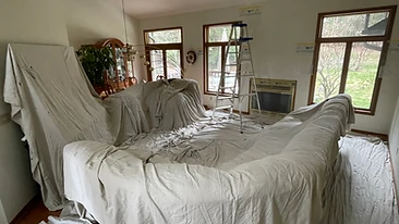Sectional sofa covered with canvas drop cloths during painting Indiana
