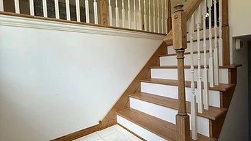 Finished staircase with white spindles and oak handrail Indiana
