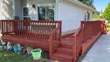 Freshly stained wooden deck and handicap accessible ramp Indiana