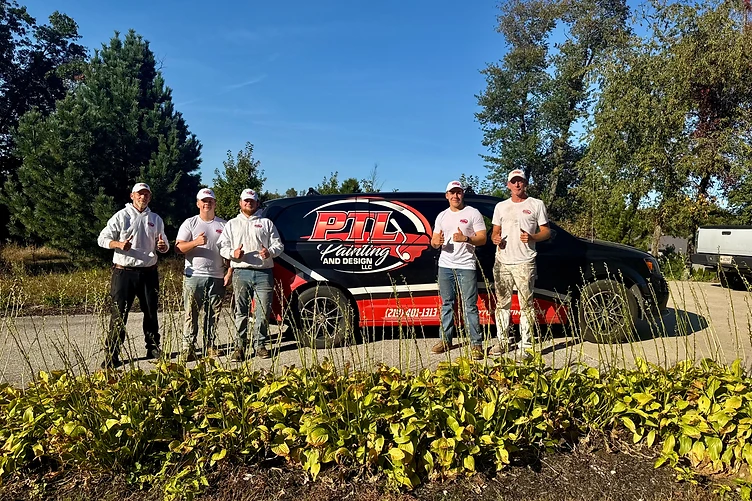 PTL Painting and Design owners and crew standing in front of the company work van giving a thumbs up