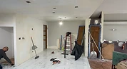 Room under renovation with primer walls and tools before painting Indiana