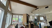 Vaulted ceiling room with drywall patches before painting Indiana